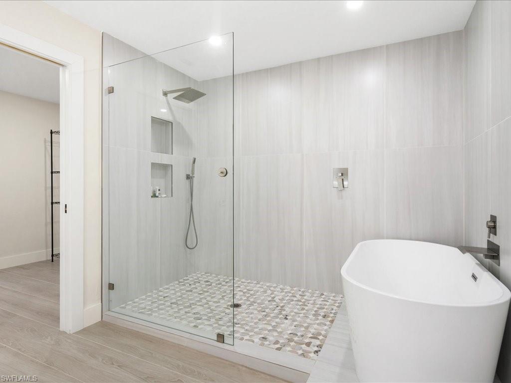 6800 Bottlebrush Lane Naples, FL 34109 - Photo 6 of 12 a bathroom with a granite countertop sink and shower