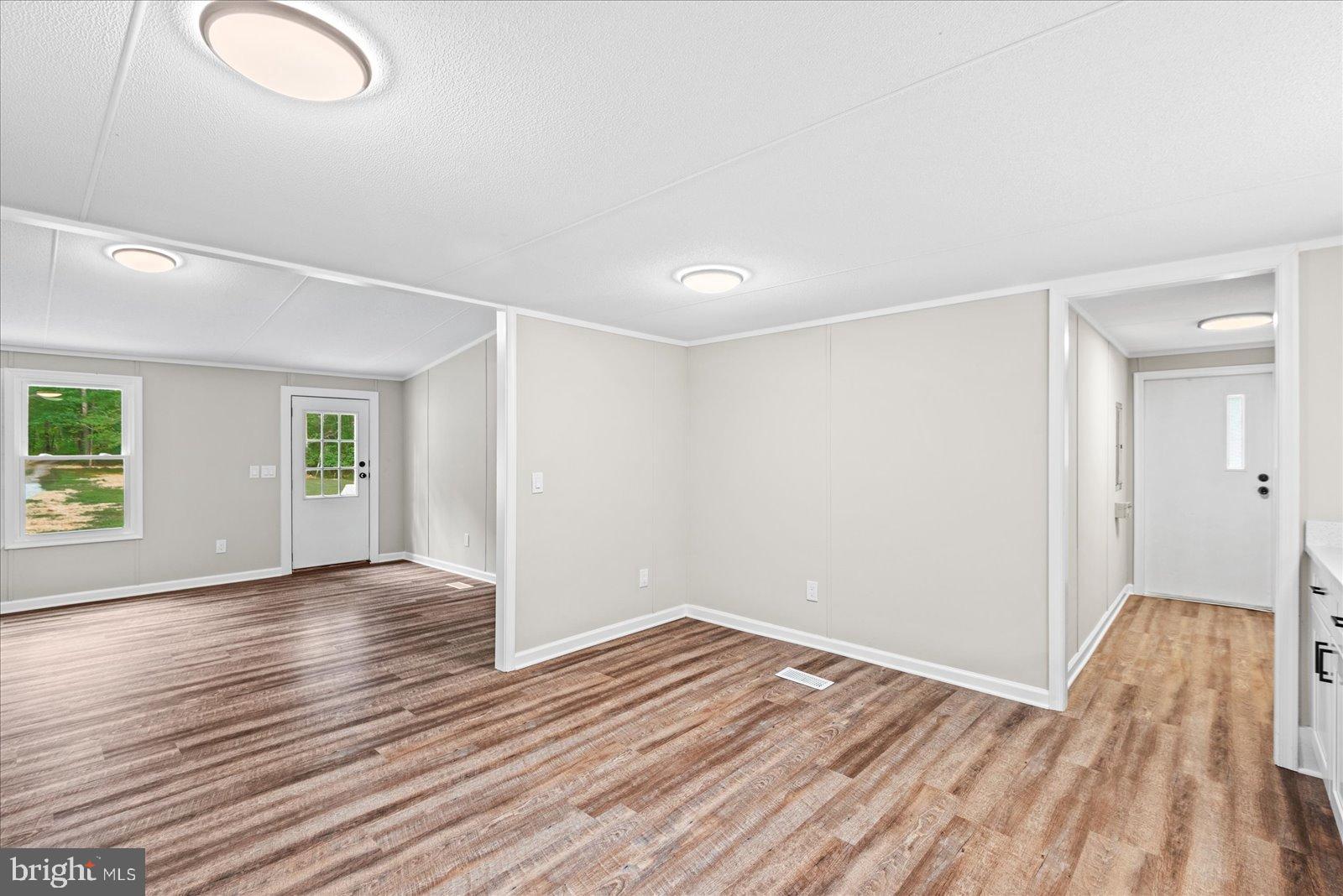 20105 Sparta Road Milford, VA 22514 - Photo 17 of 48 an empty room with wooden floor and windows