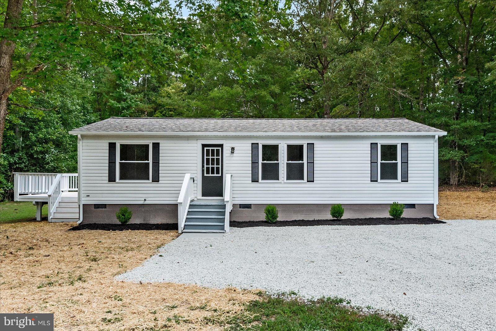 20105 Sparta Road Milford, VA 22514 - Photo 2 of 48 a front view of a house with a garden