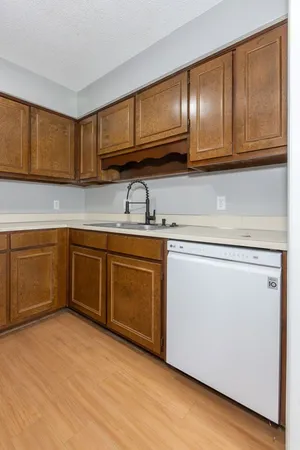 a kitchen with stainless steel appliances granite countertop a sink dishwasher stove and cabinets