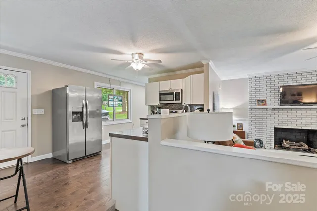 a view of living room with furniture and a fireplace