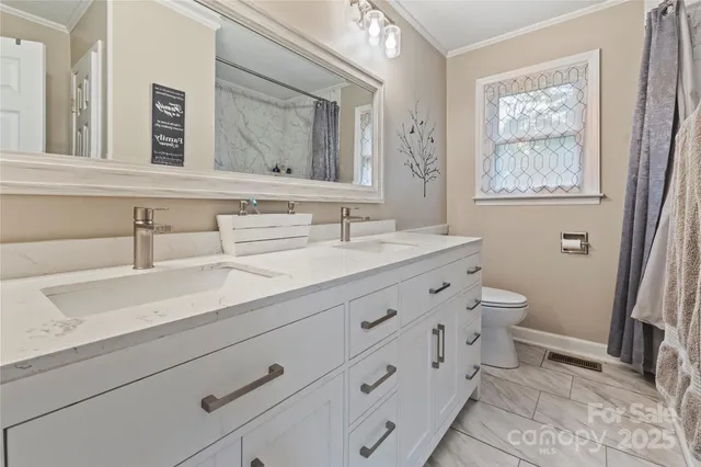 a bathroom with a double vanity sink and a mirror