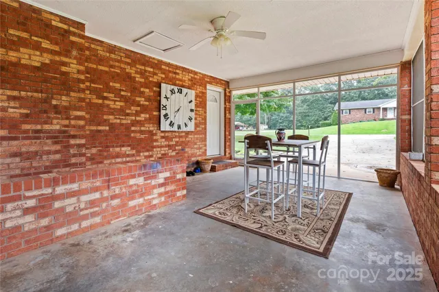 a living room with fireplace furniture and a floor to ceiling window