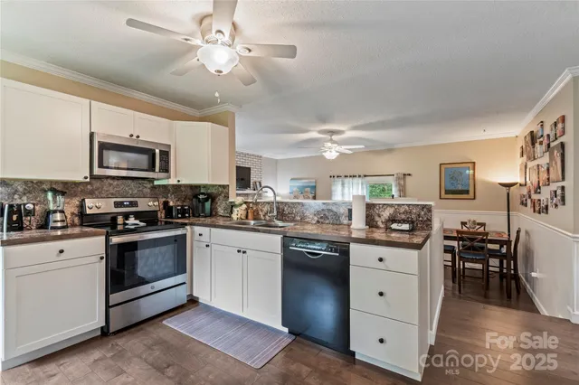 a kitchen with a sink stove and microwave