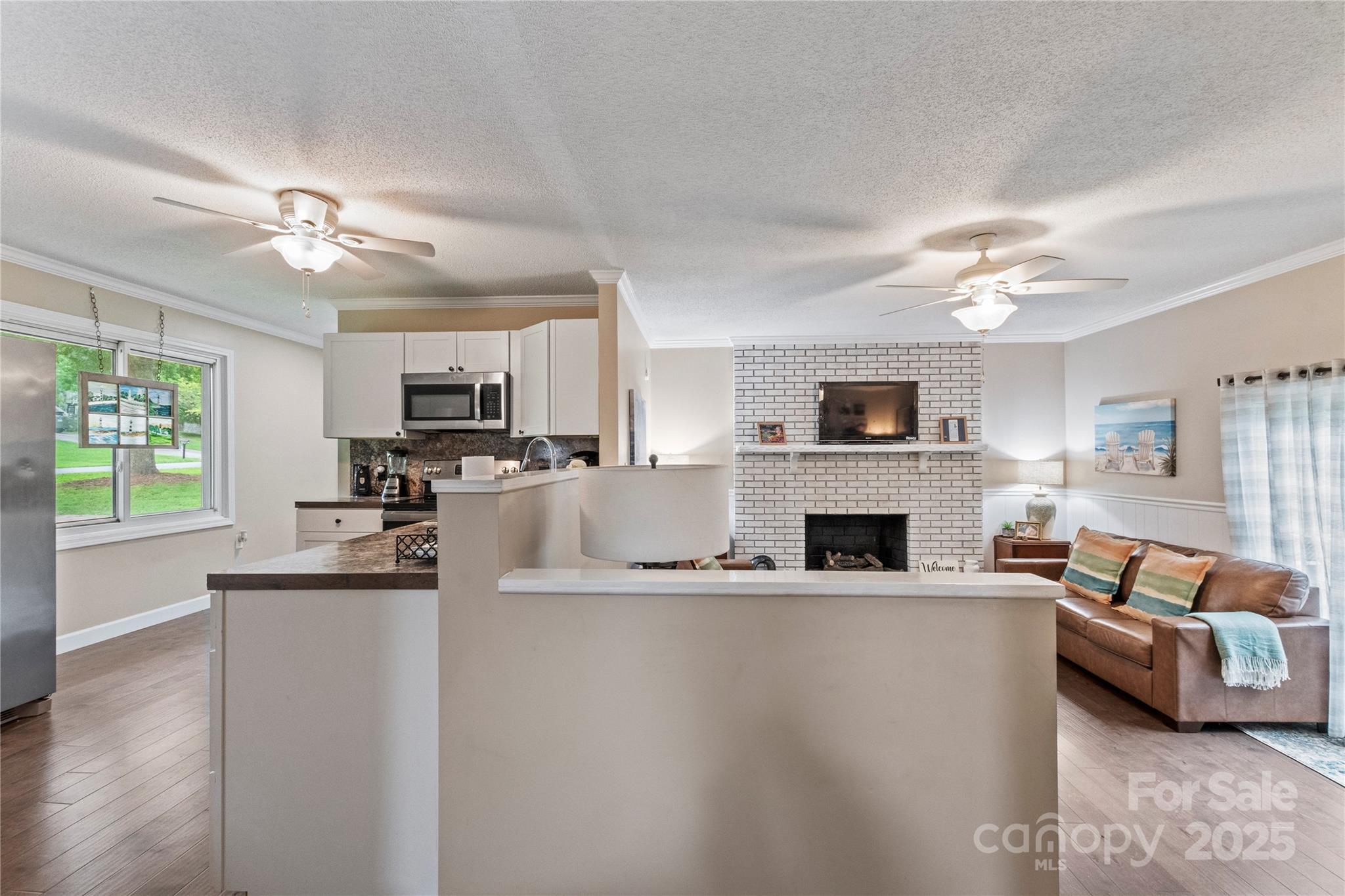 4515 Diamond Street Hudson, NC 28638 - Photo 9 of 26 a living room with furniture a fireplace and a flat screen tv