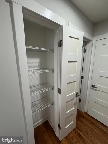 a view of walk in closet with empty racks