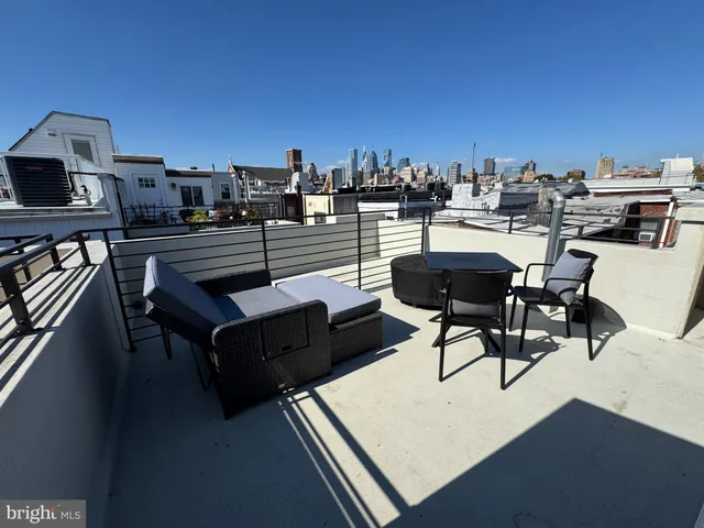 a view of a terrace with chairs and a potted plant