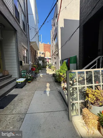a view of a patio with table and chairs potted plants