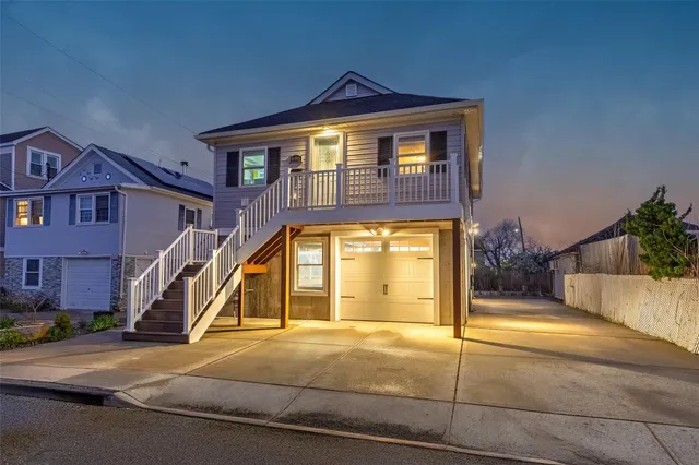 a view of a house with a yard and potted plants