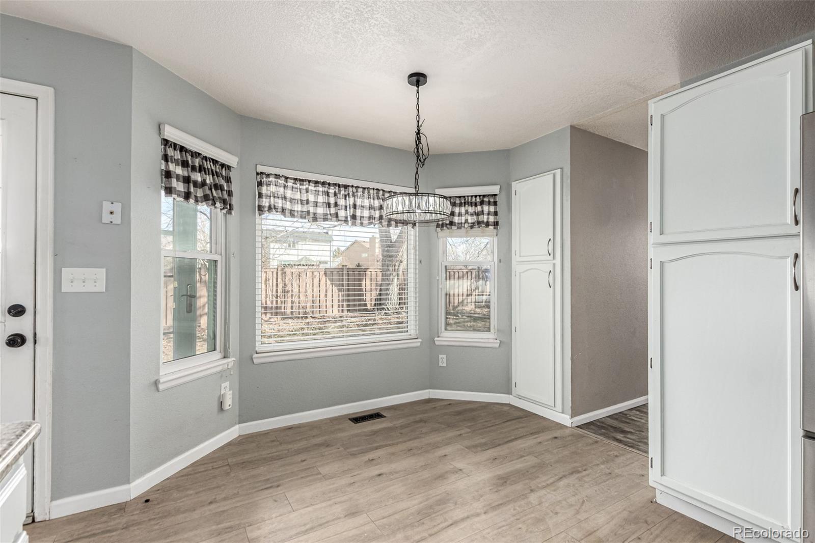 3623 West Rosewalk Circle Highlands Ranch, CO 80129 - Photo 11 of 44 a view of an empty room with window and chandelier