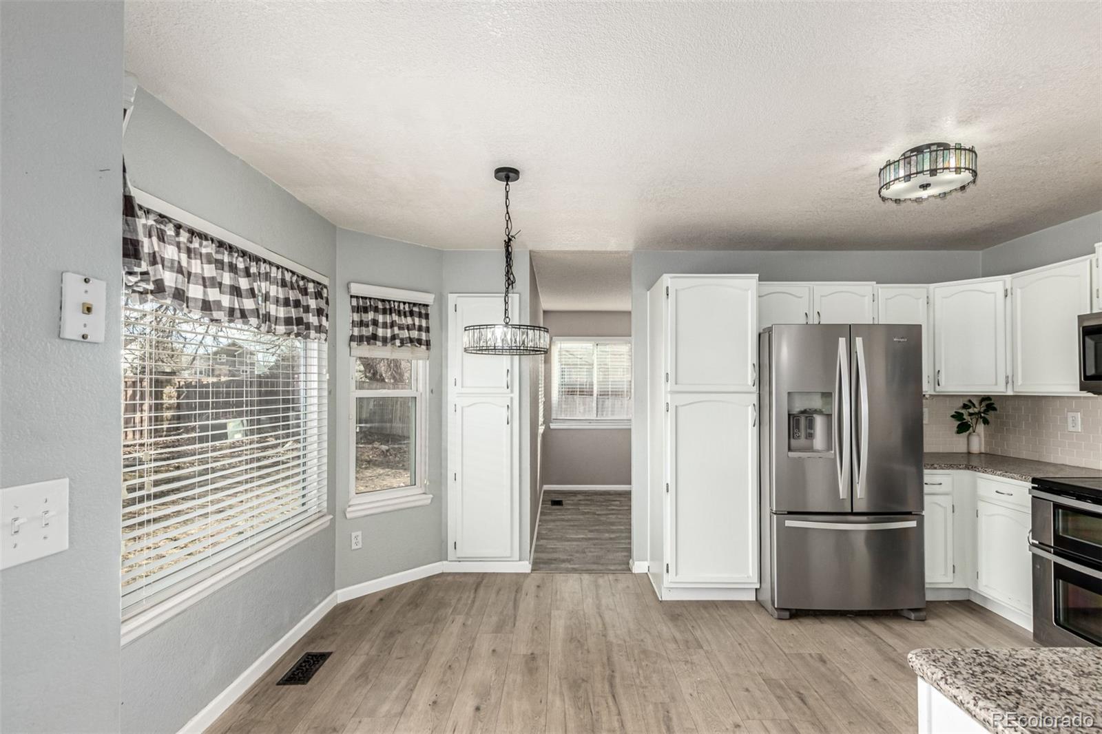 3623 West Rosewalk Circle Highlands Ranch, CO 80129 - Photo 12 of 44 a kitchen with stainless steel appliances a refrigerator and a stove top oven