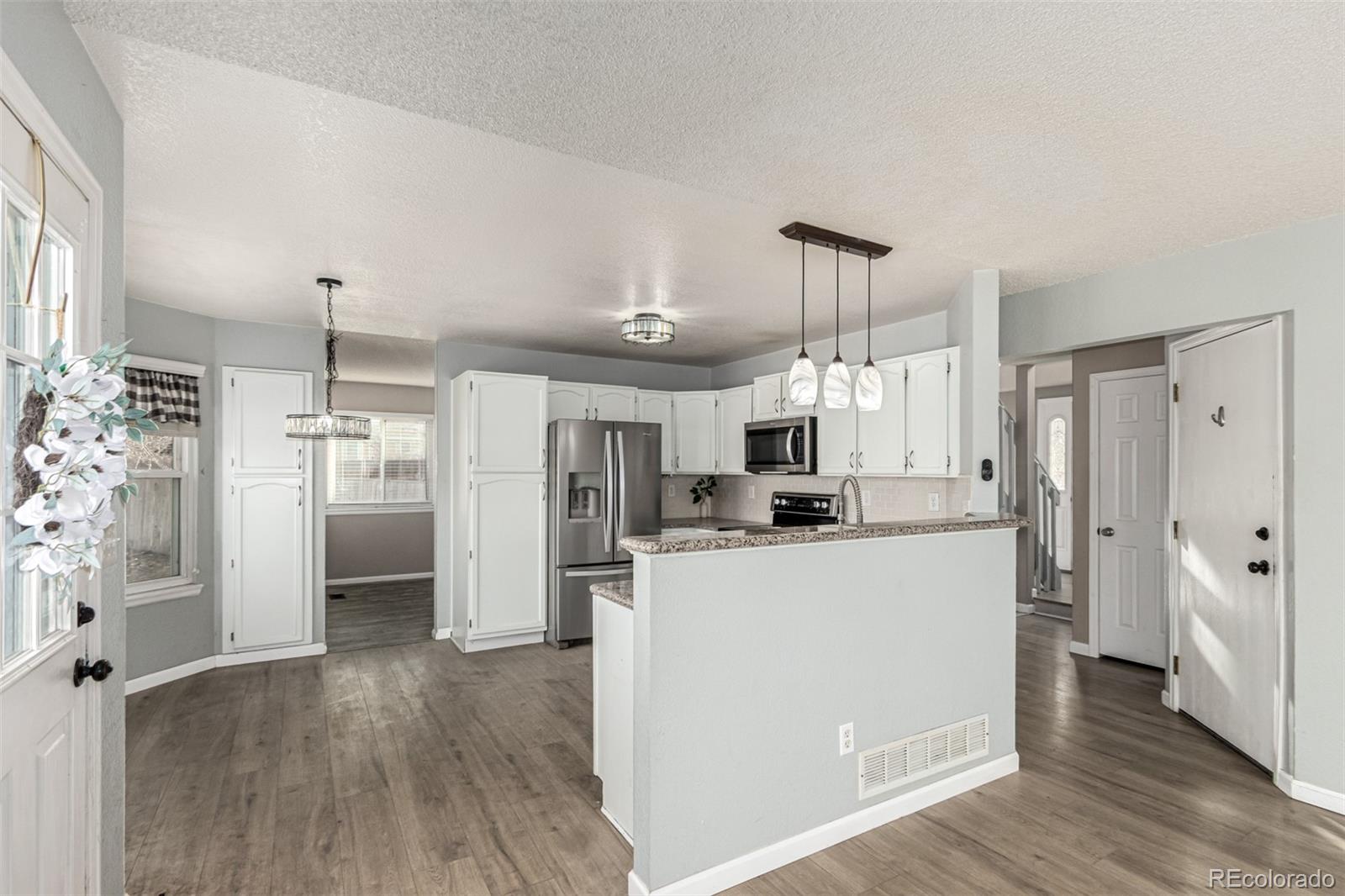 3623 West Rosewalk Circle Highlands Ranch, CO 80129 - Photo 13 of 44 a kitchen with refrigerator and cabinets