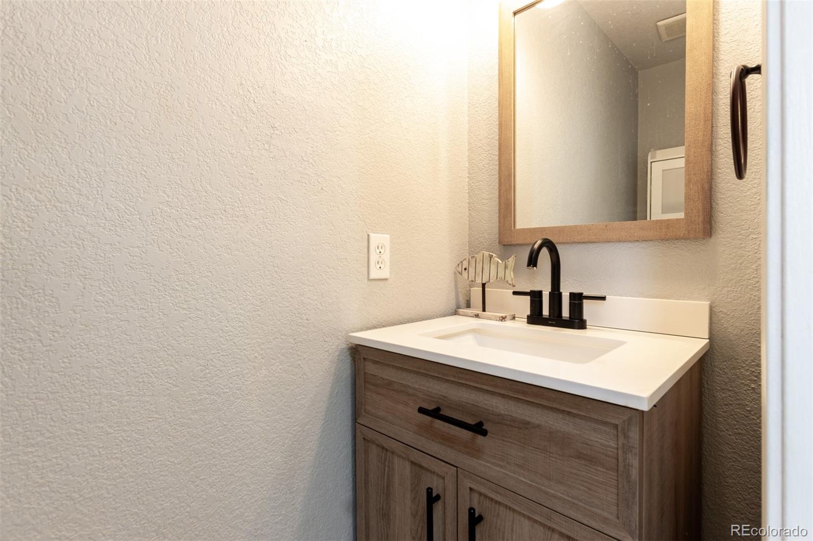 3623 West Rosewalk Circle Highlands Ranch, CO 80129 - Photo 19 of 44 a bathroom with a sink and a mirror