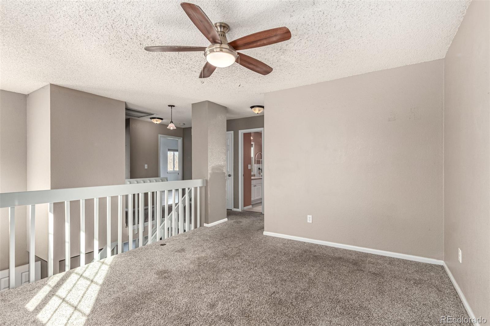 3623 West Rosewalk Circle Highlands Ranch, CO 80129 - Photo 21 of 44 an empty room with ceiling fan and windows