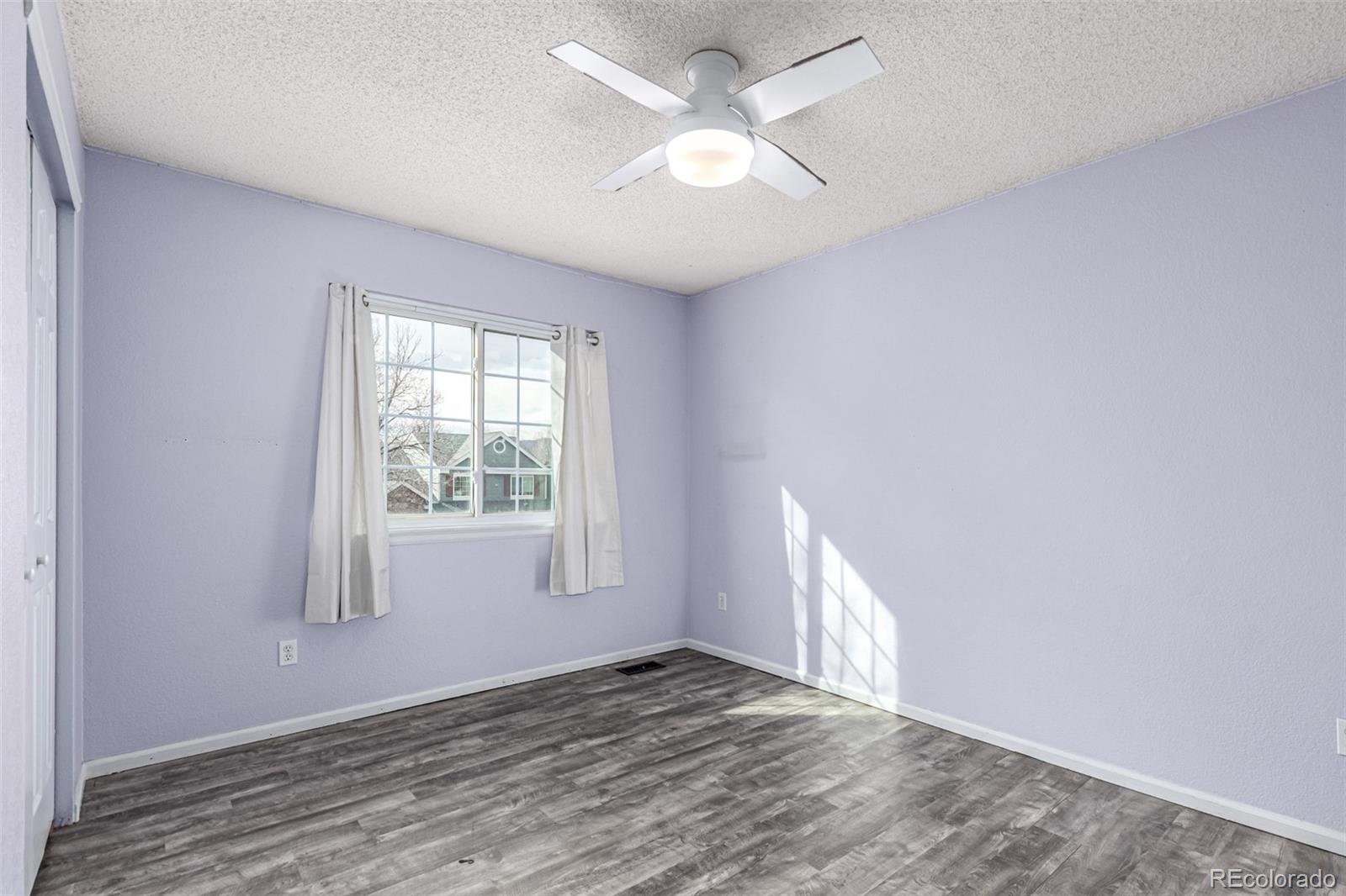 3623 West Rosewalk Circle Highlands Ranch, CO 80129 - Photo 29 of 44 wooden floor in an empty room with a window