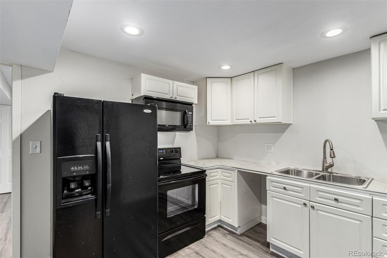 3623 West Rosewalk Circle Highlands Ranch, CO 80129 - Photo 33 of 44 a kitchen with a refrigerator sink and cabinets