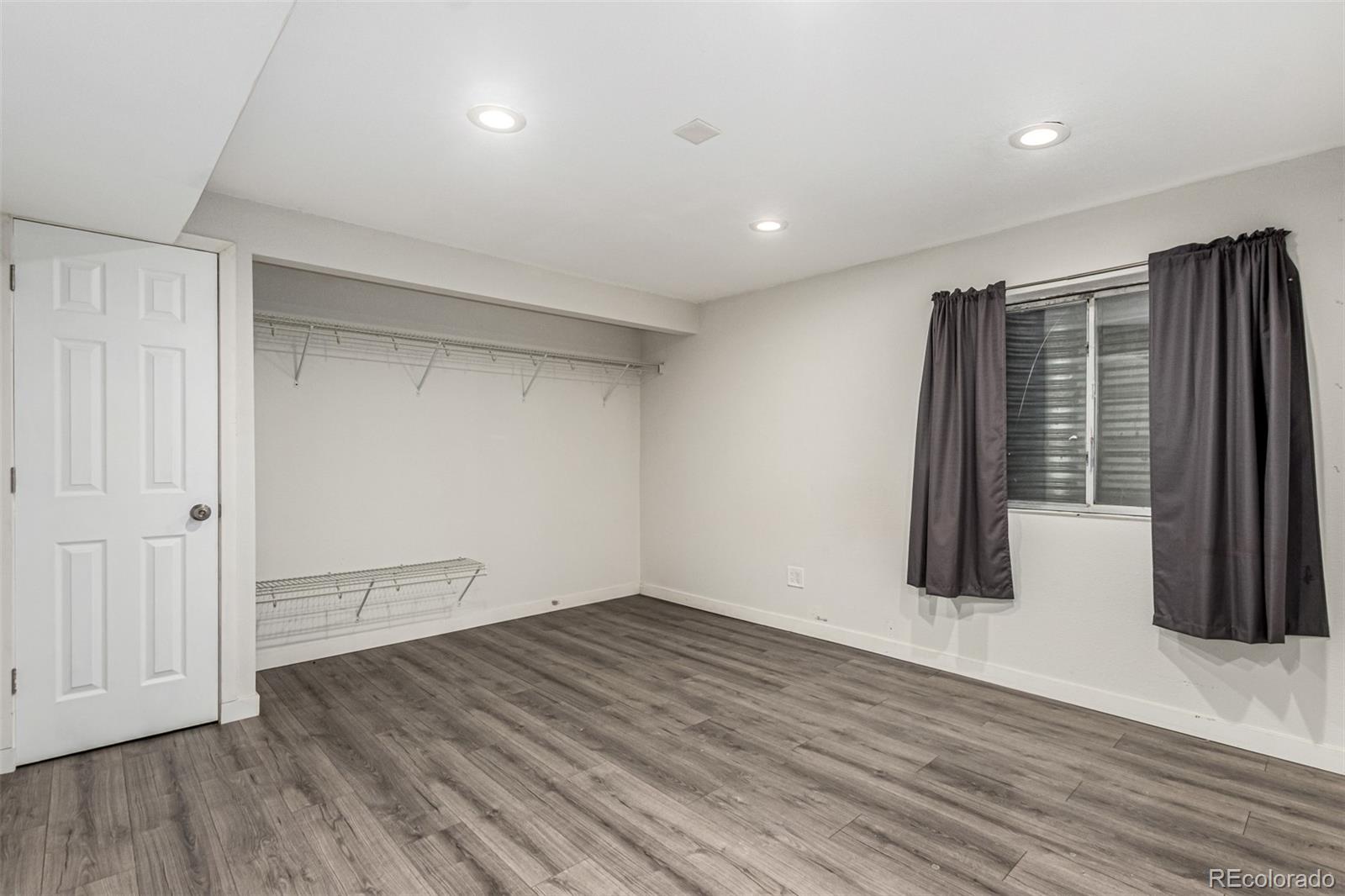 3623 West Rosewalk Circle Highlands Ranch, CO 80129 - Photo 37 of 44 wooden floor in an empty room with a window