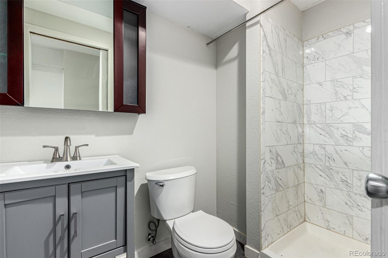 3623 West Rosewalk Circle Highlands Ranch, CO 80129 - Photo 39 of 44 a bathroom with a sink a toilet and shower