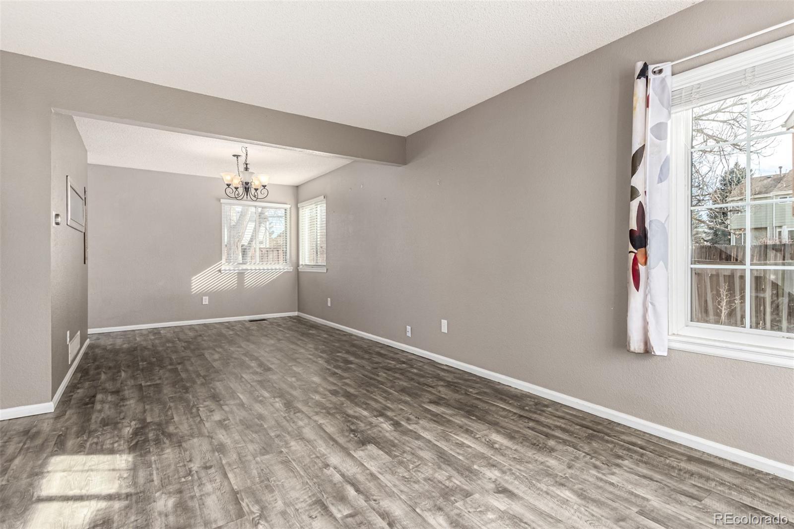 3623 West Rosewalk Circle Highlands Ranch, CO 80129 - Photo 5 of 44 a view of empty room with wooden floor and fan