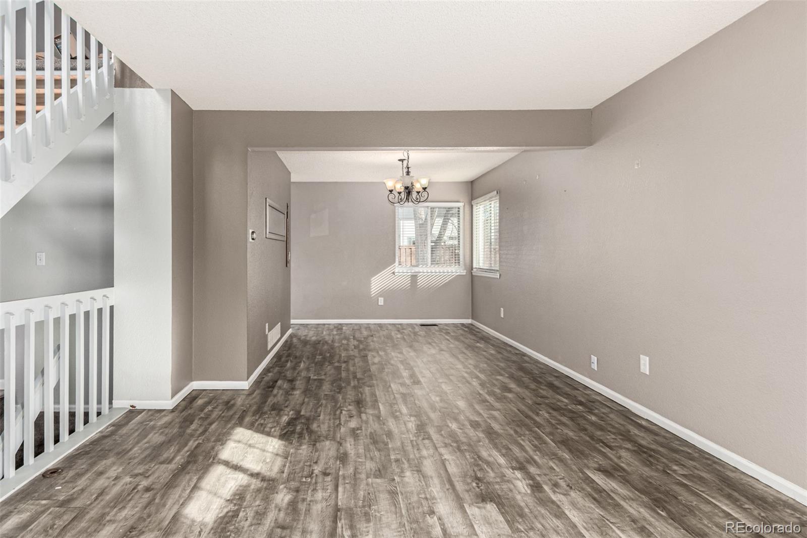 3623 West Rosewalk Circle Highlands Ranch, CO 80129 - Photo 6 of 44 a view of empty room with wooden floor and fan