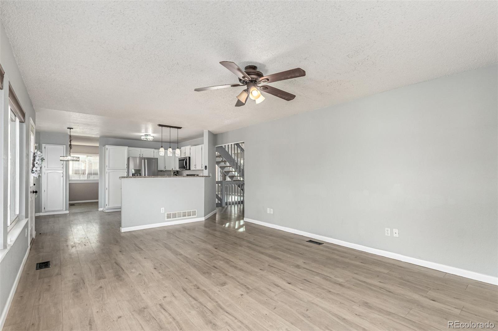 3623 West Rosewalk Circle Highlands Ranch, CO 80129 - Photo 10 of 44 a view of a kitchen with a sink and a refrigerator