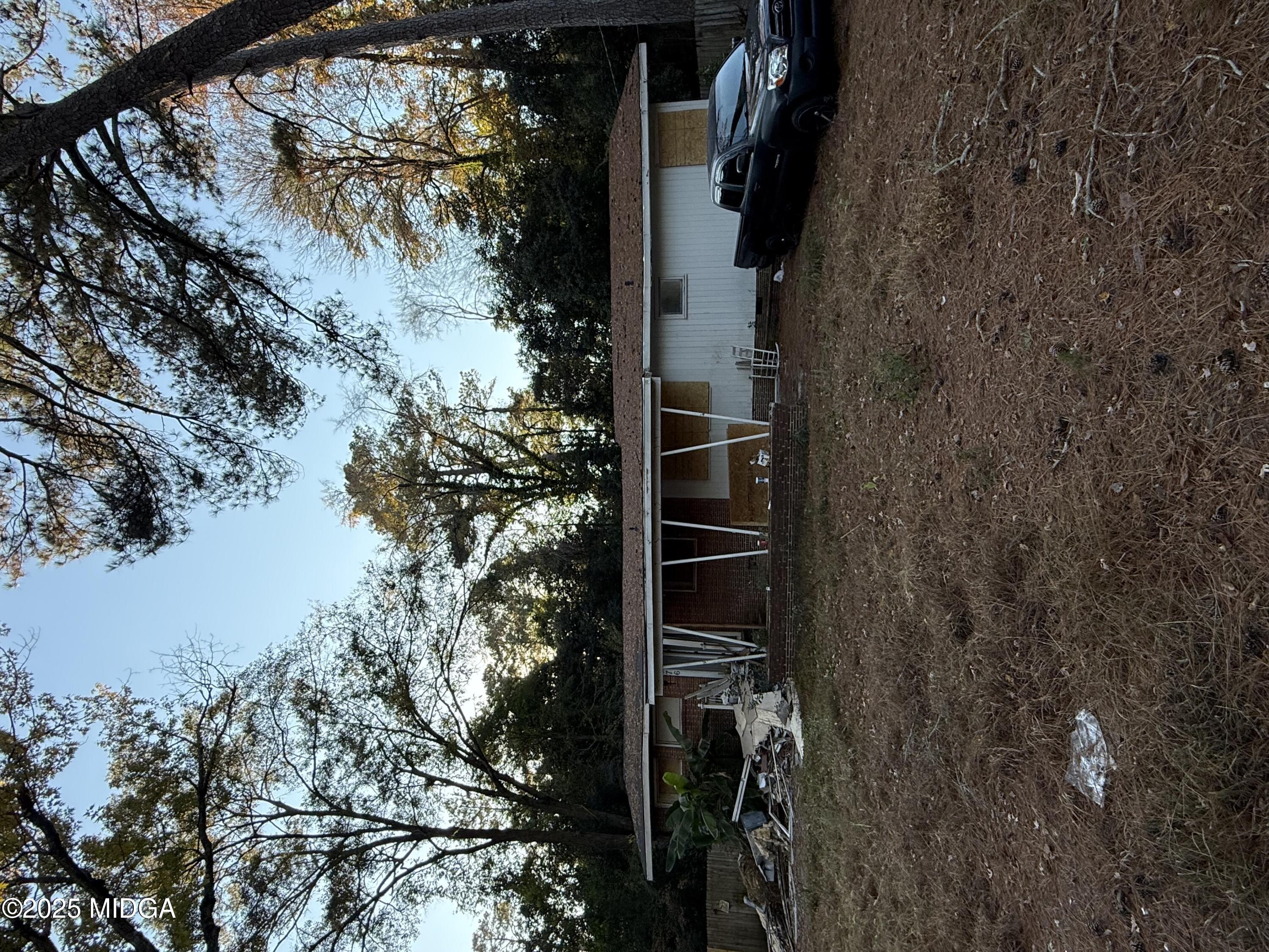 a backyard of a house with yard and outdoor seating