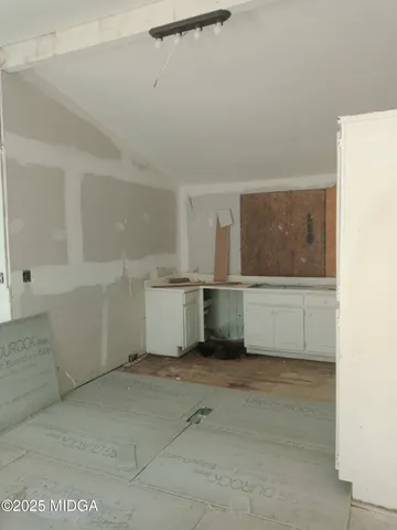 a view of a storage & utility room with cabinets