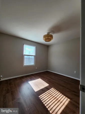 an empty room with wooden floor