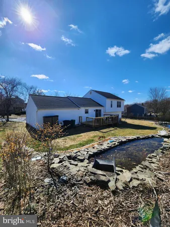 a view of a house with backyard and swimming pool