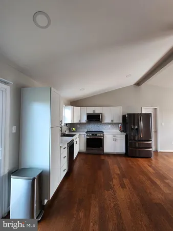 a kitchen with stainless steel appliances and a refrigerator