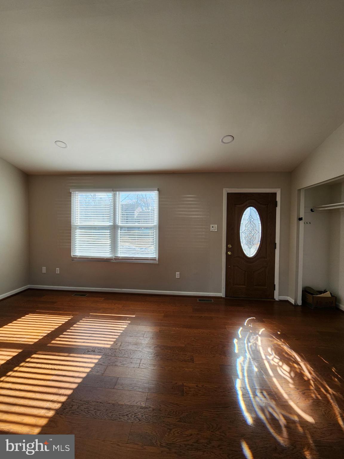 6660 Hunter Road Elkridge, MD 21075 - Photo 8 of 27 a view of an empty room with wooden floor and a window