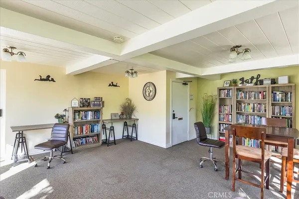 a view of a bedroom with workspace and a window