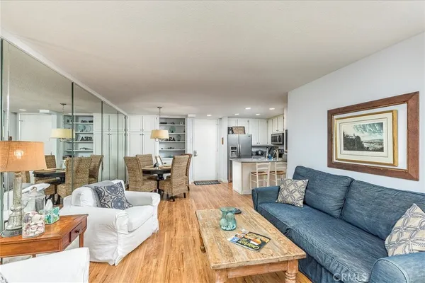 a living room with furniture and view of kitchen