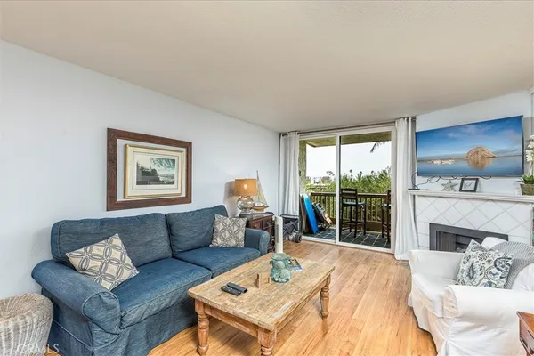 a living room with furniture a large window and a fireplace