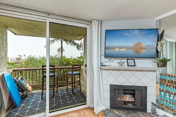 a living room with a fireplace and a floor to ceiling window