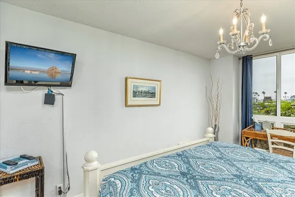 a bedroom with furniture and a flat screen tv