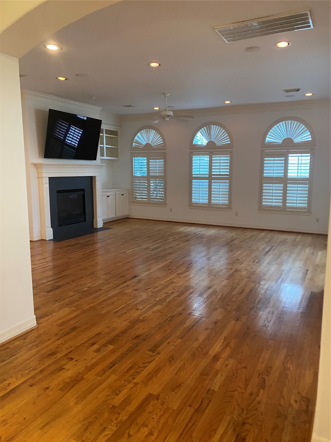 1421 Bremond Street Houston, TX 77004 - Photo 19 of 30 an empty room with wooden floor fireplace and windows