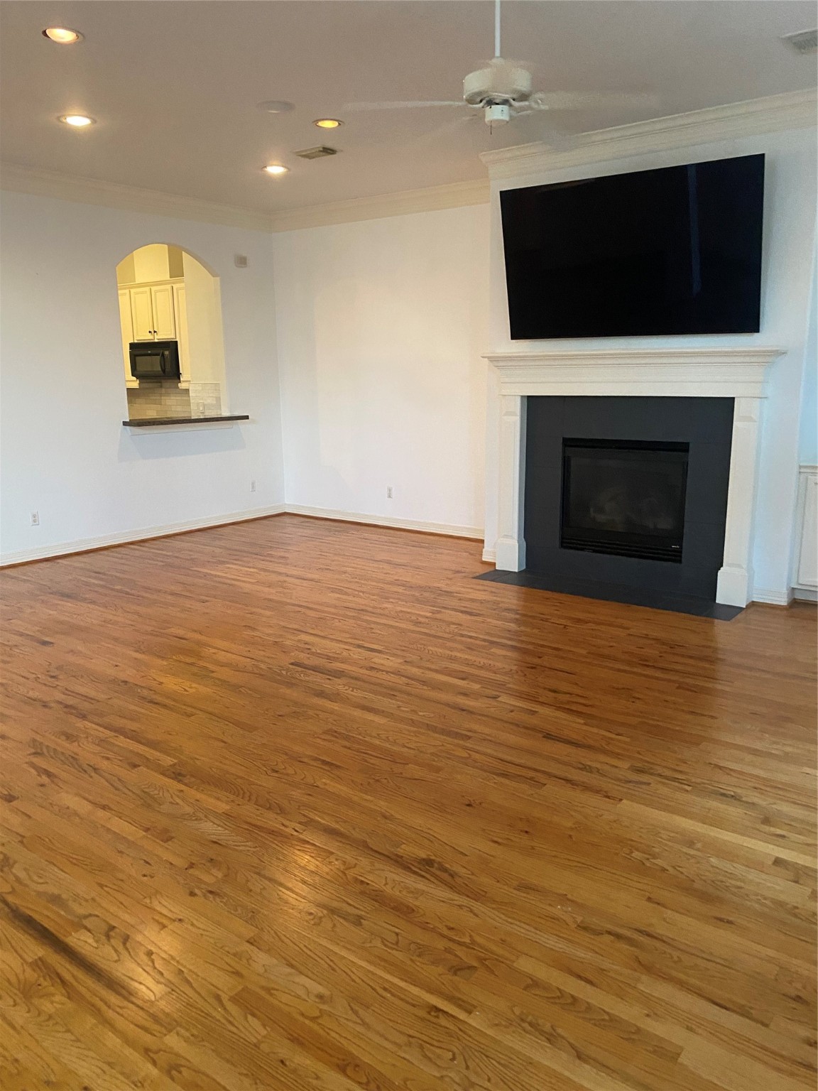 1421 Bremond Street Houston, TX 77004 - Photo 20 of 30 a view of an empty room with a fireplace and a flat screen tv