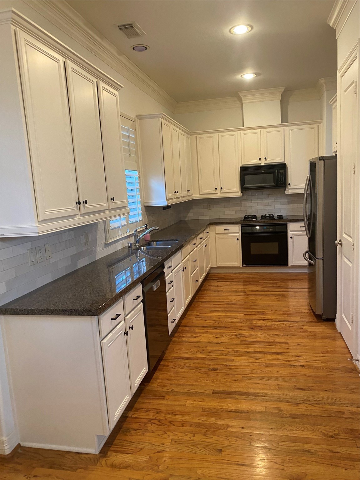 1421 Bremond Street Houston, TX 77004 - Photo 23 of 30 a kitchen with stainless steel appliances granite countertop a stove a sink and a refrigerator