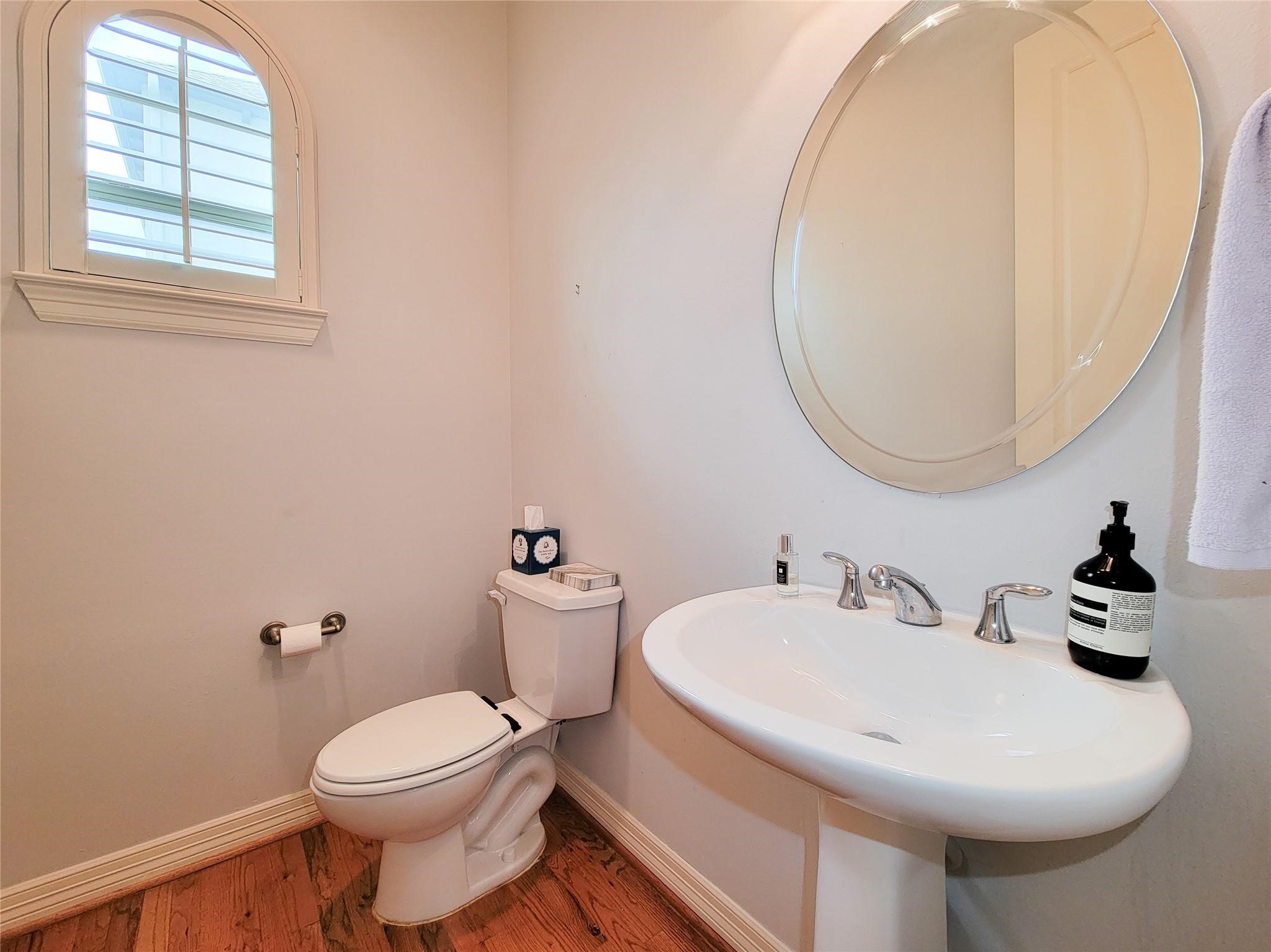 1421 Bremond Street Houston, TX 77004 - Photo 10 of 30 a bathroom with a toilet sink and mirror