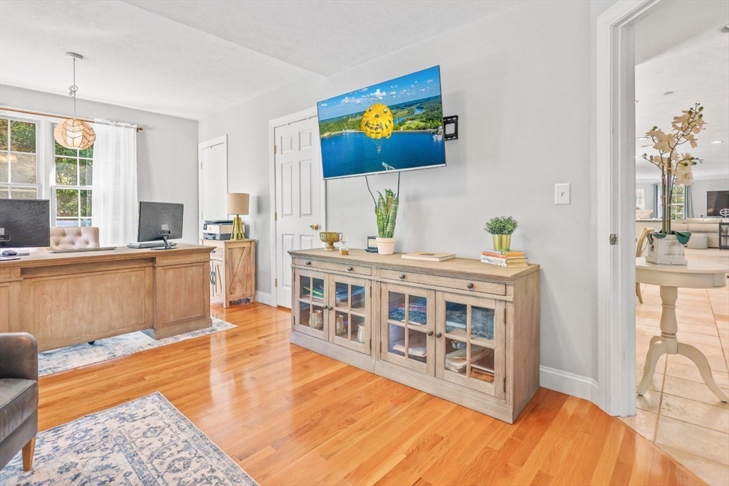 50 Rocky Brook Road North Andover, MA 01845 - Photo 15 of 42 a living room with stainless steel appliances kitchen island granite countertop a couch a dining table and chairs with wooden floor