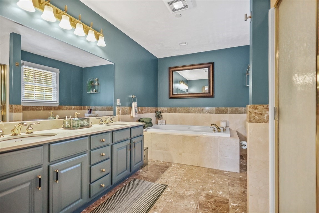 50 Rocky Brook Road North Andover, MA 01845 - Photo 23 of 42 a bathroom with a tub a sink and mirror