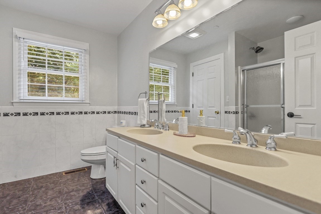 50 Rocky Brook Road North Andover, MA 01845 - Photo 26 of 42 a bathroom with a granite countertop toilet a sink a mirror and a window