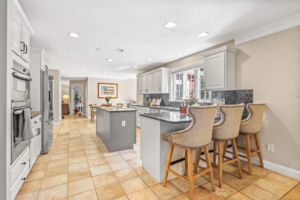 50 Rocky Brook Road North Andover, MA 01845 - Photo 6 of 42 a kitchen with a table chairs refrigerator and window