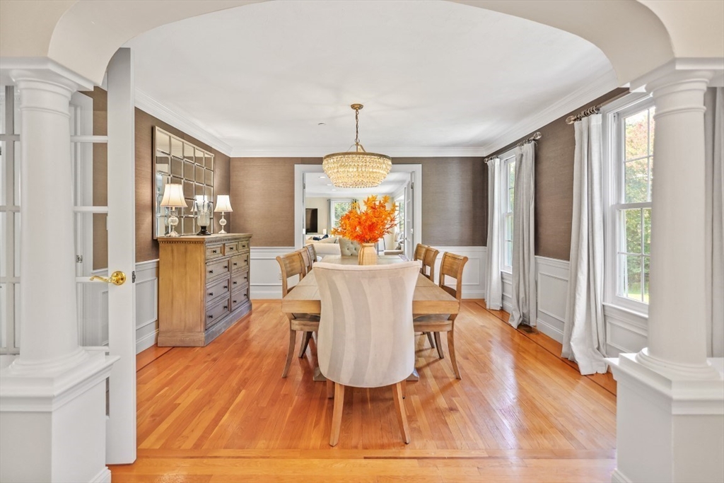 50 Rocky Brook Road North Andover, MA 01845 - Photo 9 of 42 a dining room with wooden floor a chandelier a wooden table and chairs
