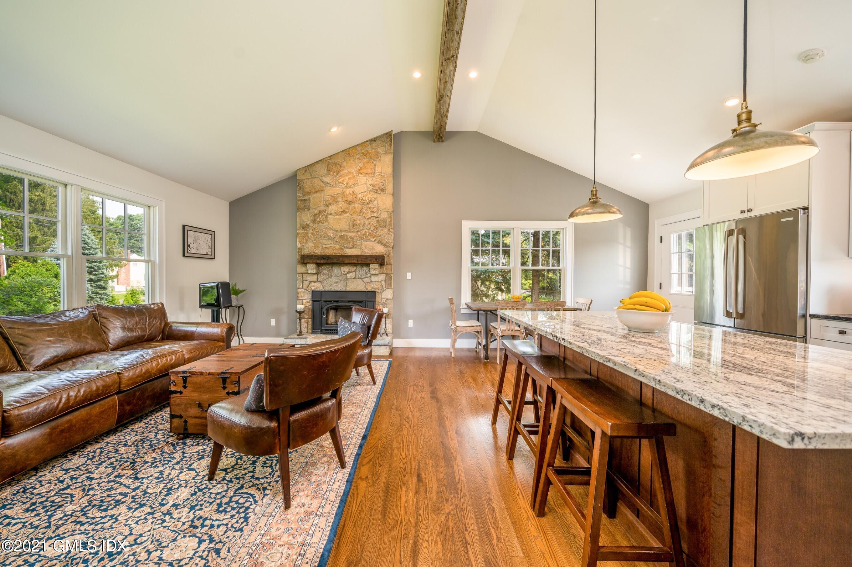 47 Cognewaugh Road Cos Cob, CT 06807 - Photo 8 of 44 a living room with fireplace furniture and a large window