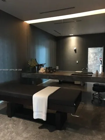 a hallway with table and chairs