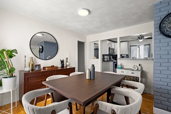 a kitchen with a table chairs sink and cabinets