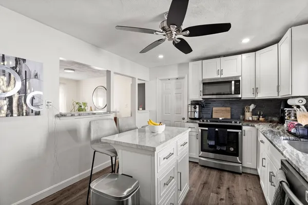 a kitchen with stainless steel appliances a sink stove and cabinets
