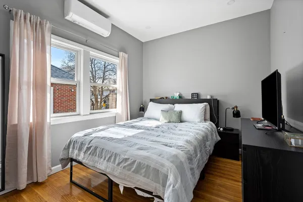 a bed sitting in a bedroom next to a window